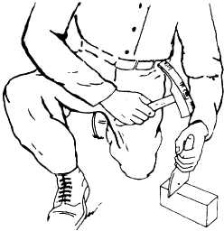 Cutting brick with a chisel